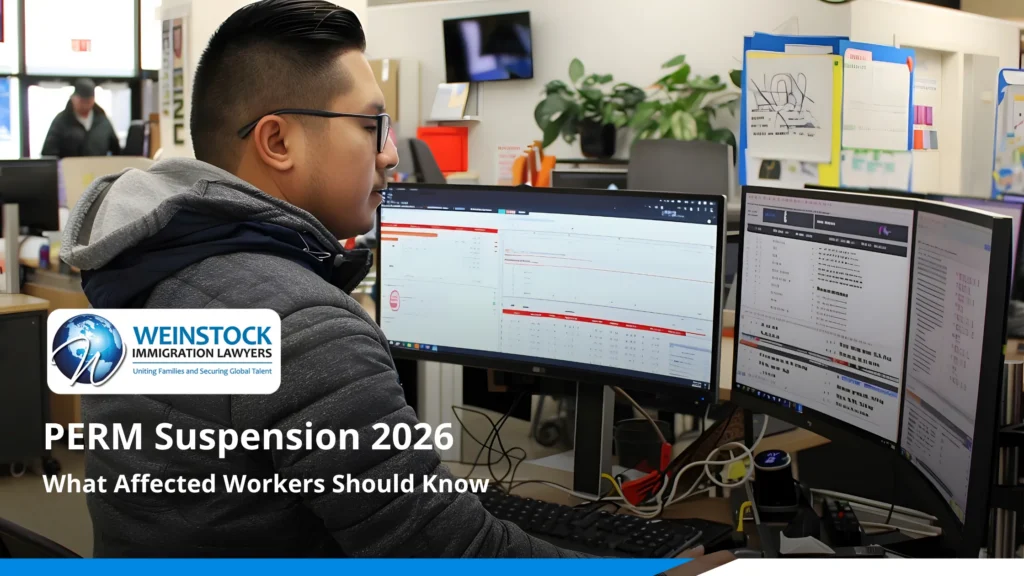 Tech worker at a desk with two monitors, with the title PERM Suspension 2026: What Affected Workers Should Know